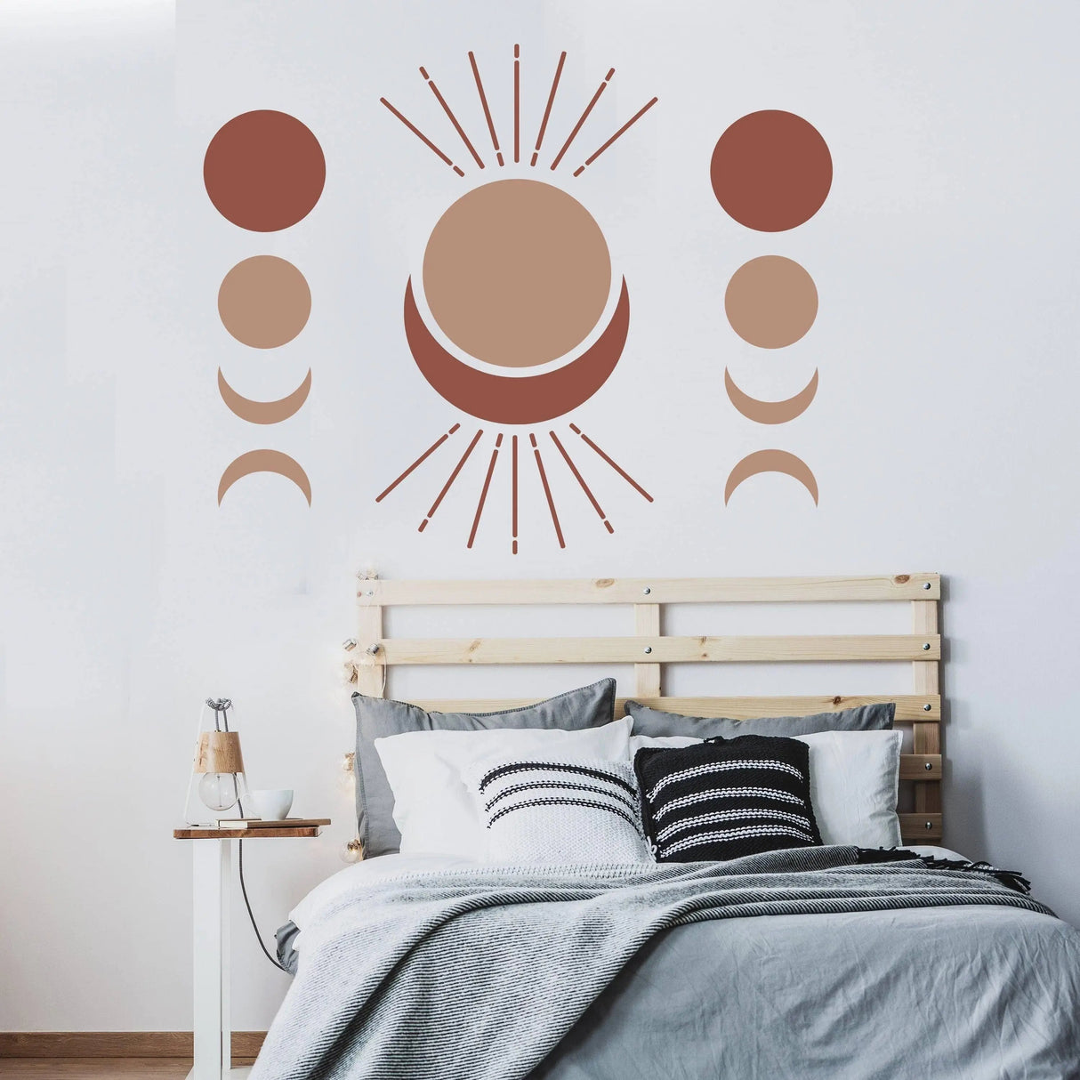 Bohemian crescent and moon phases wall art decal above a stylish bed.