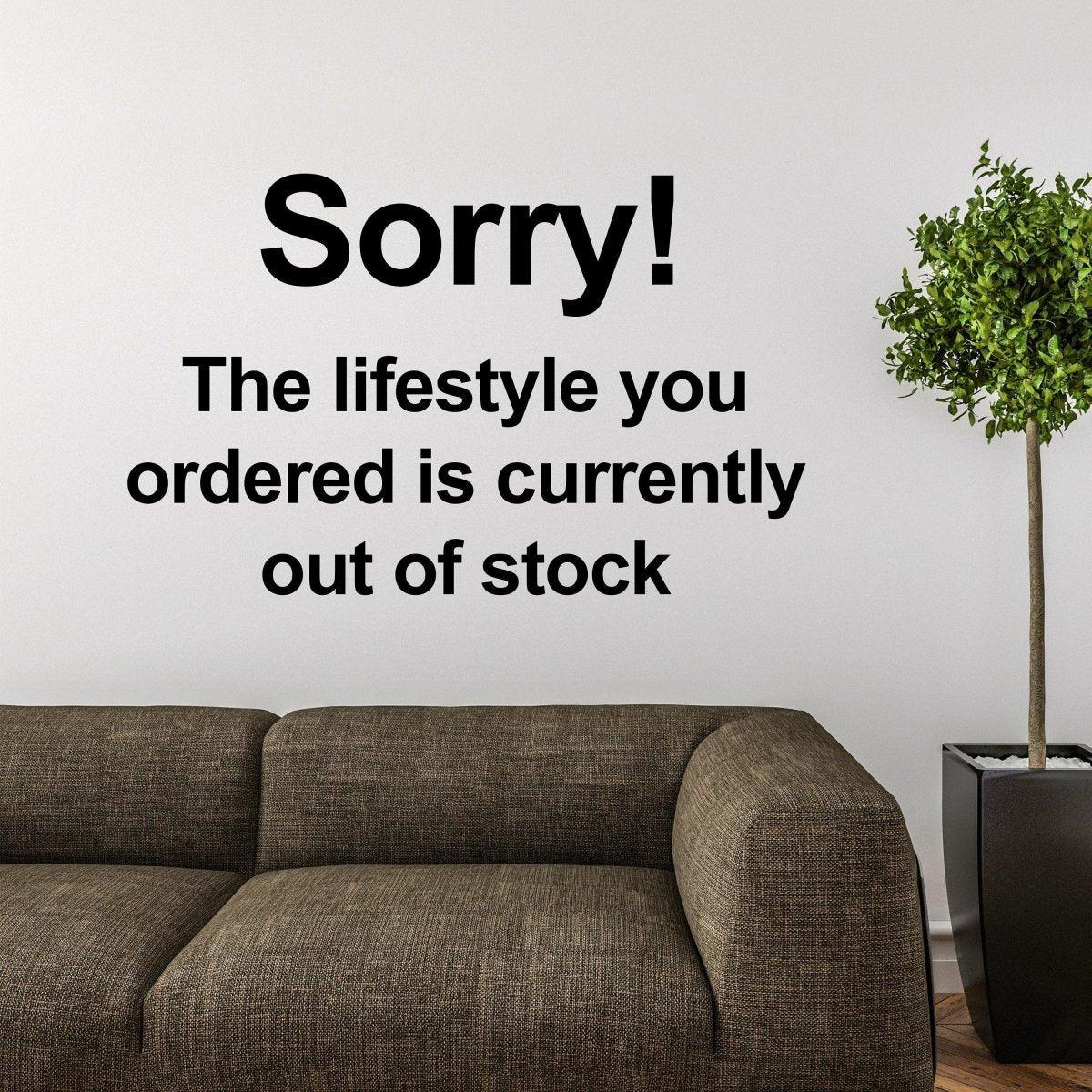 Sorry Quote street art wall decal displayed above a modern sofa.