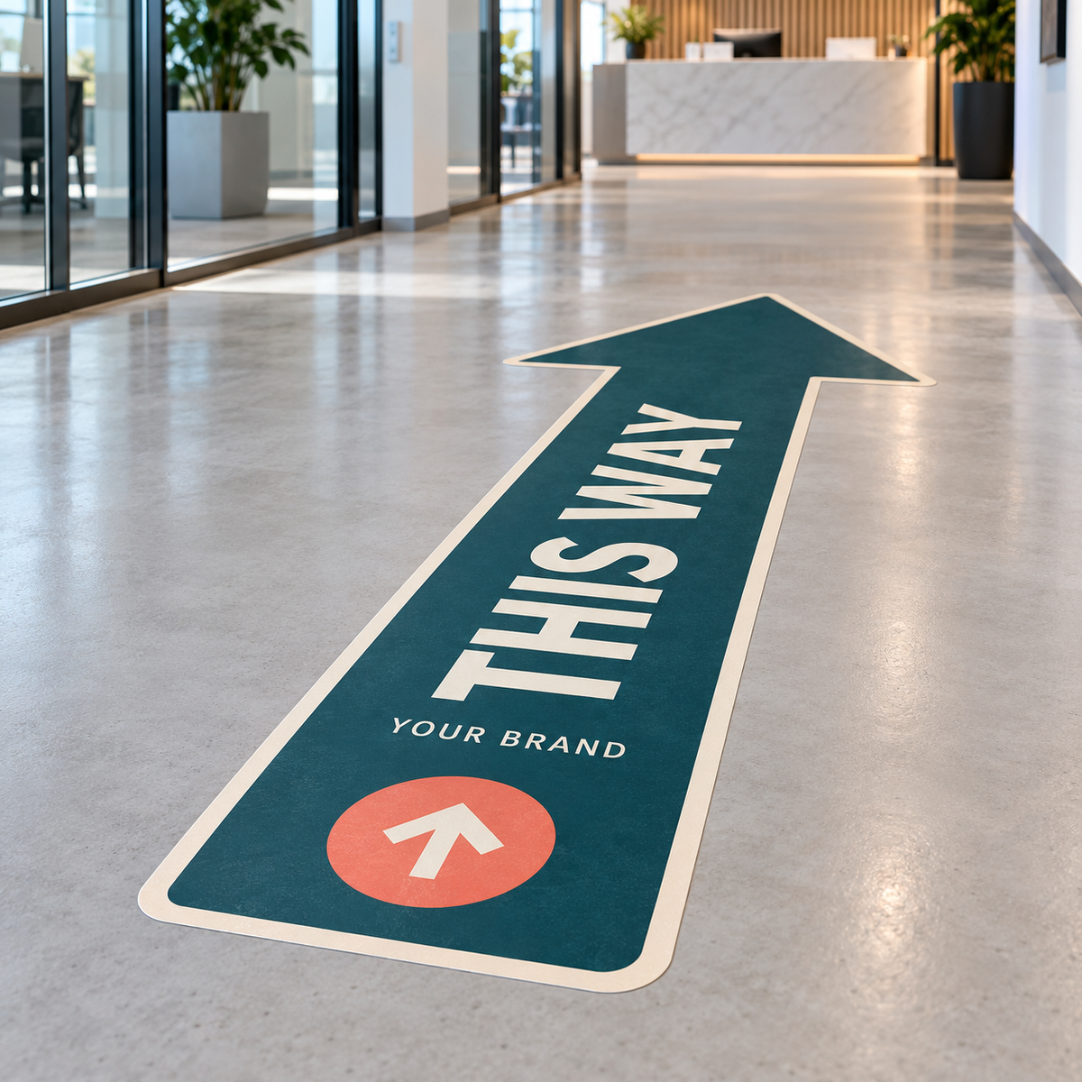 Example of a custom arrow floor sticker with This Way lettering in a reception corridor