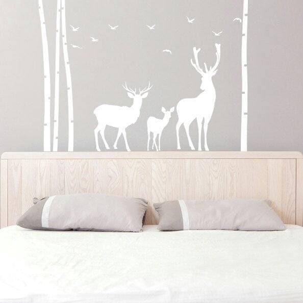 Nature-inspired wall decal featuring deer and trees.