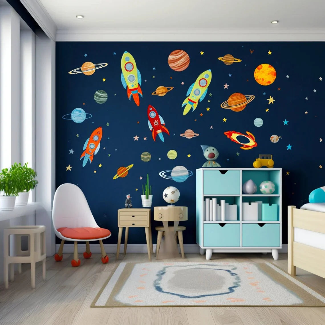 Colorful rocket, planet and star wall decals on a navy-blue accent wall in a children's room with white shelves.