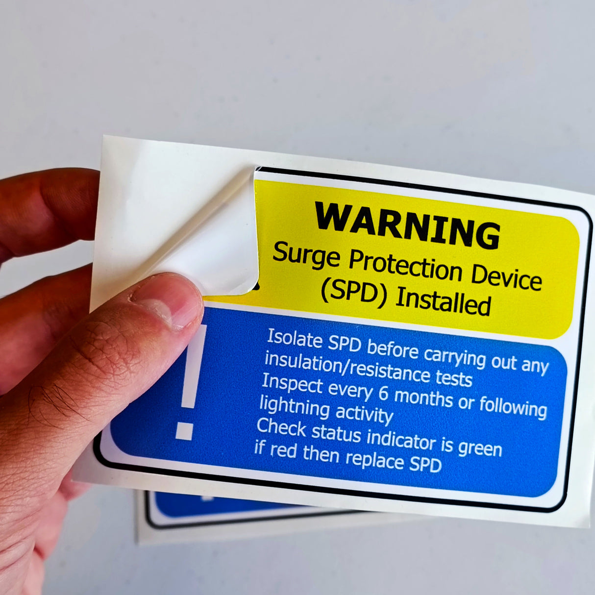 Alternate product view of 6x Surge Protection Device (SPD) Warning Label.