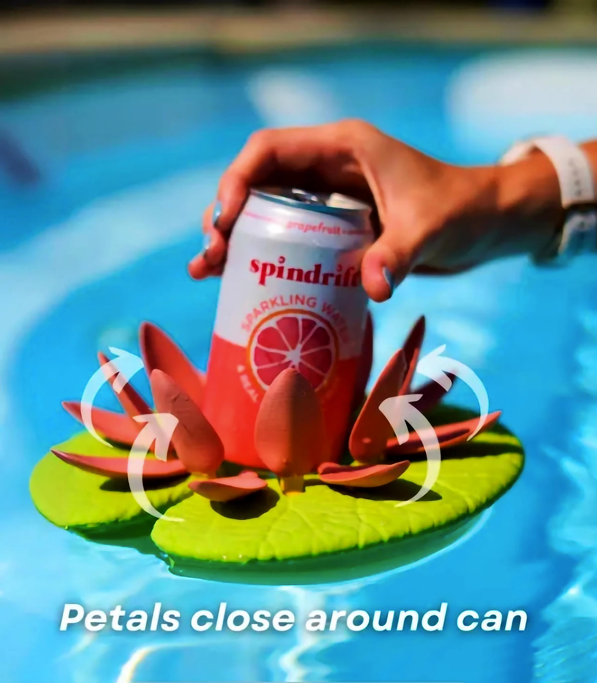 Floating lily pad cupholder stabilizing a drink can in a pool, featuring self-adjusting petals for secure hold.