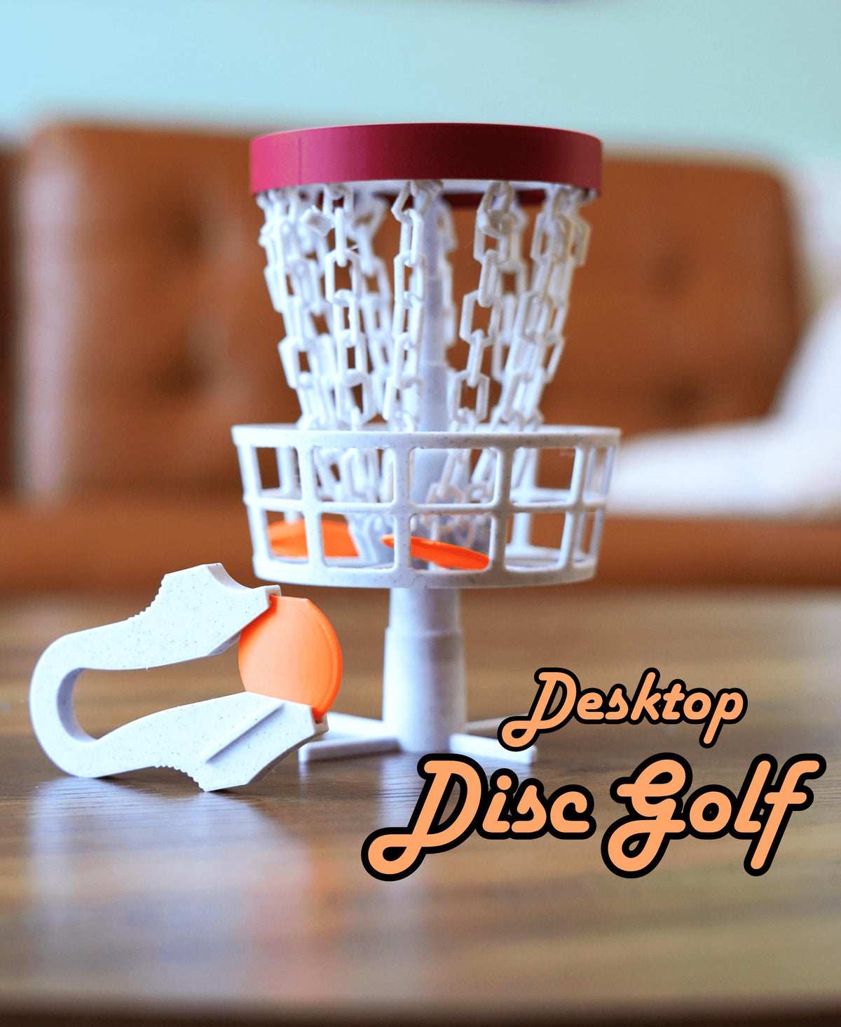 Mini desktop disc golf basket with chains and launcher.