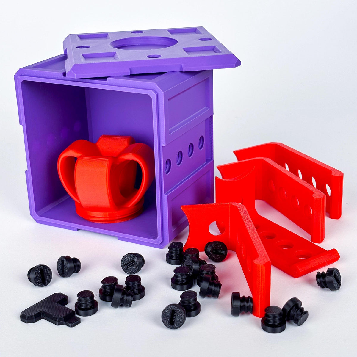 Colorful 3D-printed annoying gift box with red puzzle piece and bolts.