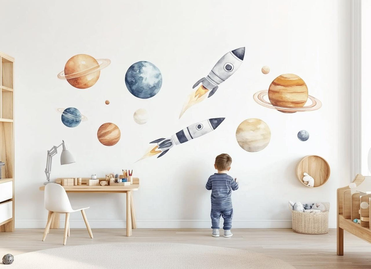 Child’s bedroom wall decorated with watercolor rockets and planets in warm orange and beige tones.