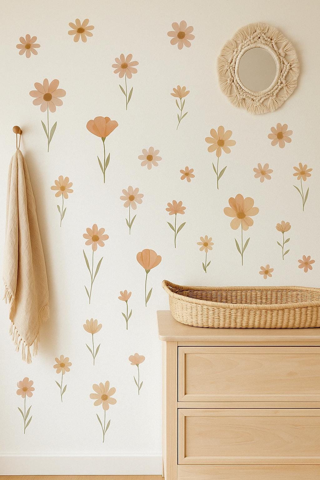 A nursery wall decorated with soft boho-style floral wall decals in neutral tones of peach, beige, and sage.