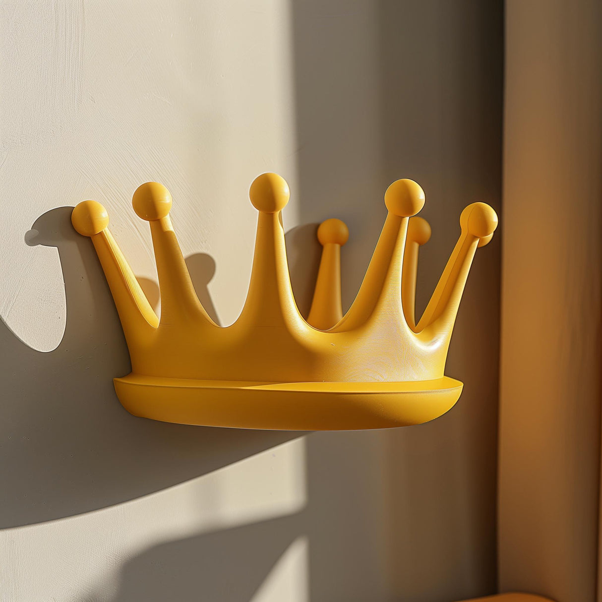 3D printed yellow crown-shaped wall shelf made from matte PLA.