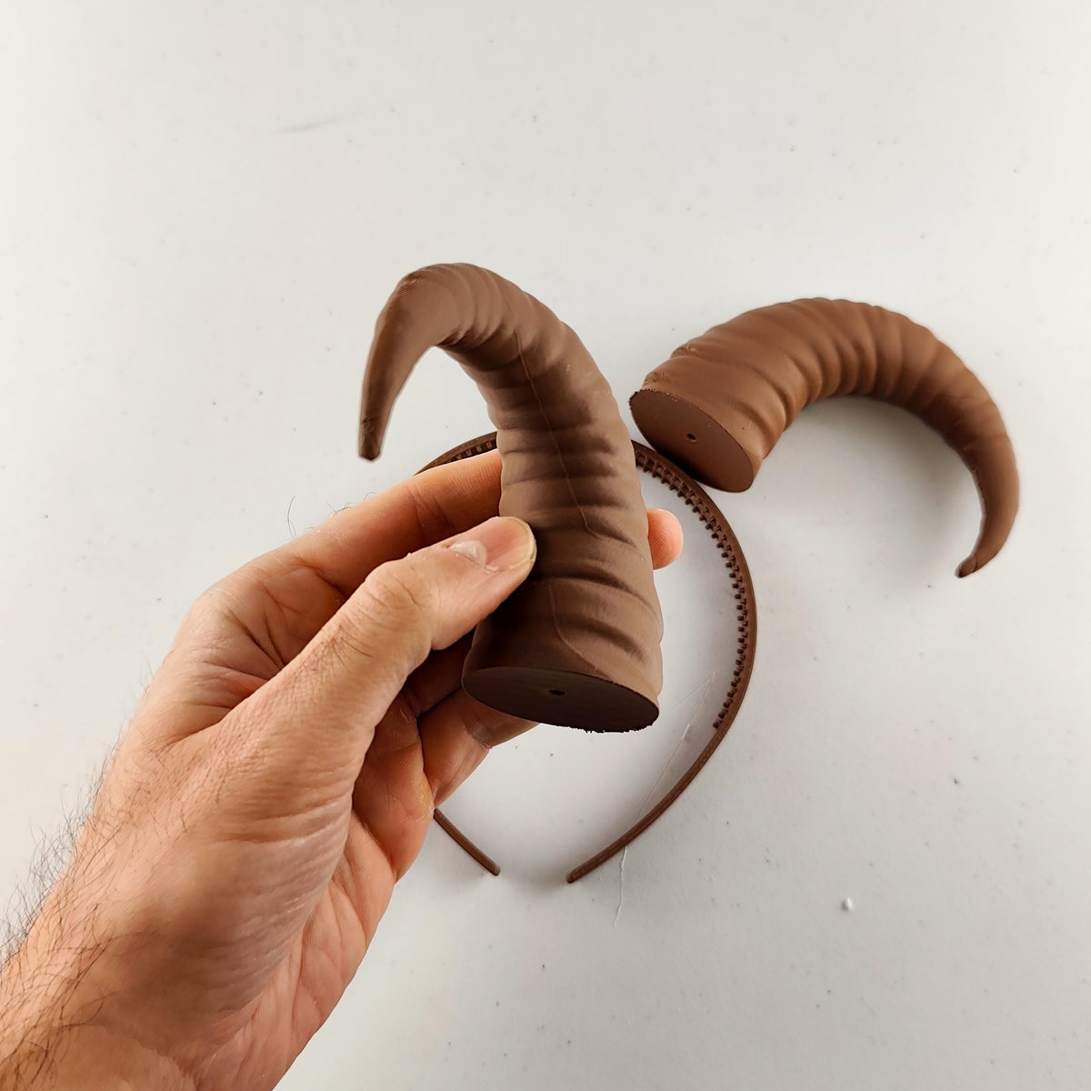 Product gallery view of 3D Printed Curved Ram Horns Headband.