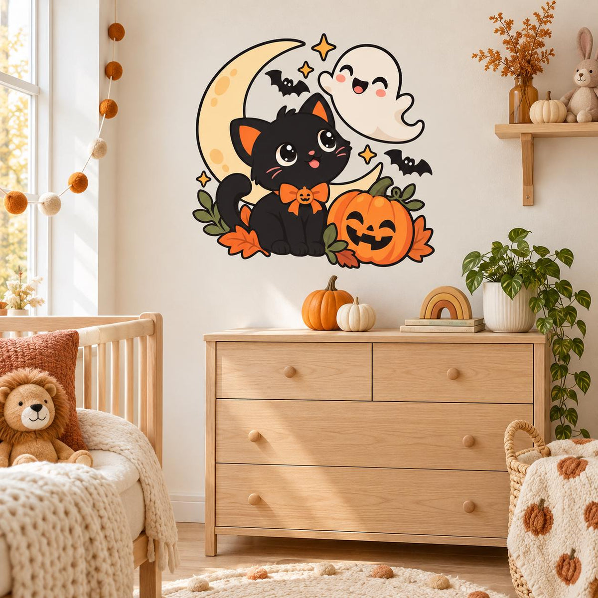 Black cat, white ghost and pumpkin wall decal above a nursery dresser beside a wooden crib.