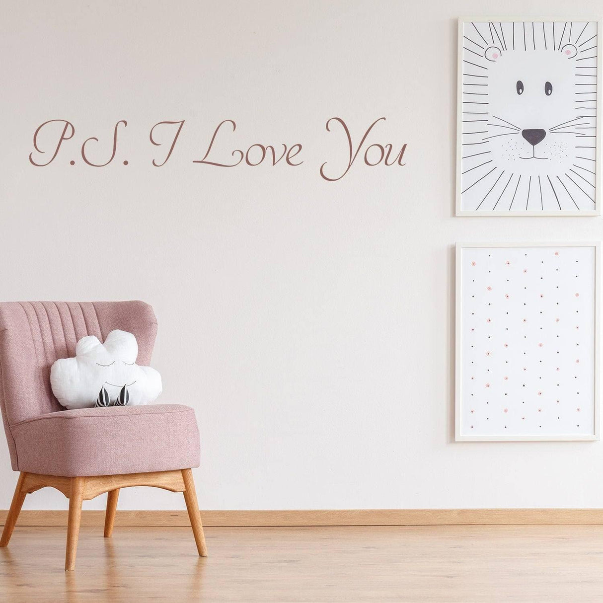 Romantic wall decal with 'P.S. I Love You' text above a pink chair and framed art.