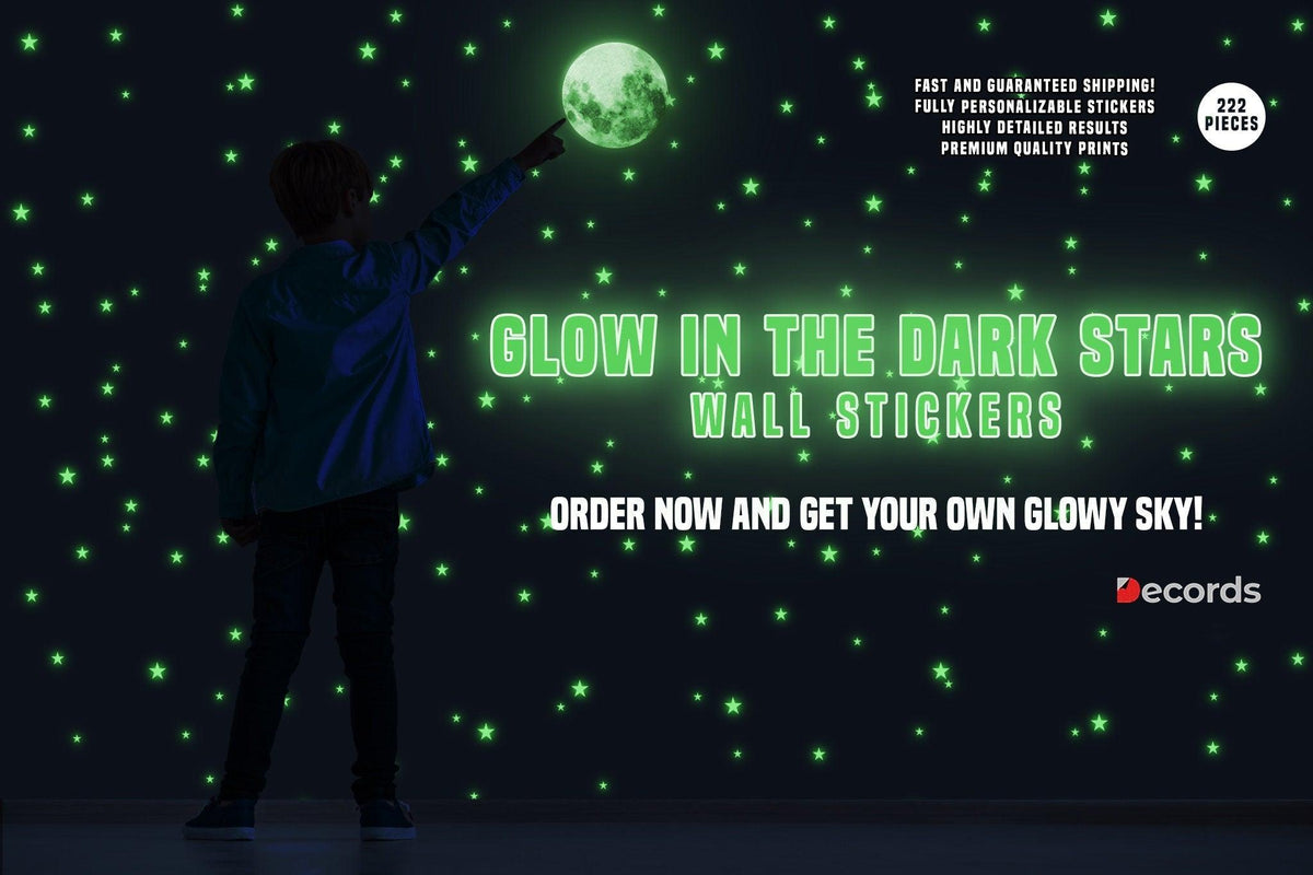 Child reaching for glowing moon and stars wall stickers in a dark room, featuring 222 glow-in-the-dark pieces.