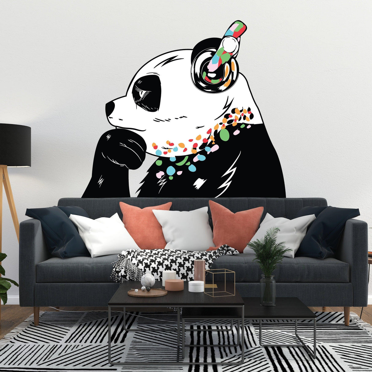 Panda in headphones street art wall decal above a sofa in a modern living room.