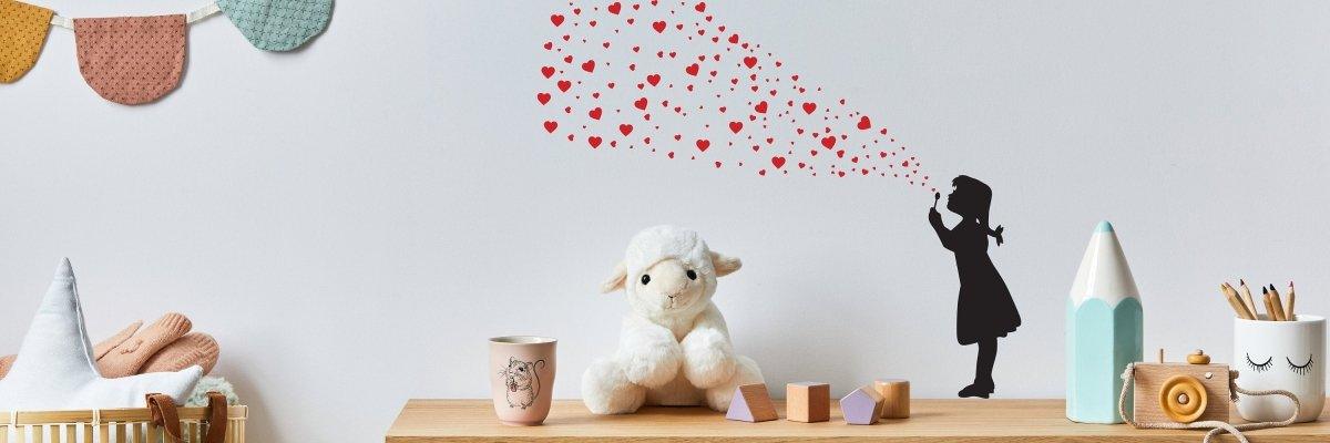 Girl wall decal blowing hearts, vibrant street art sticker for creative home decor.