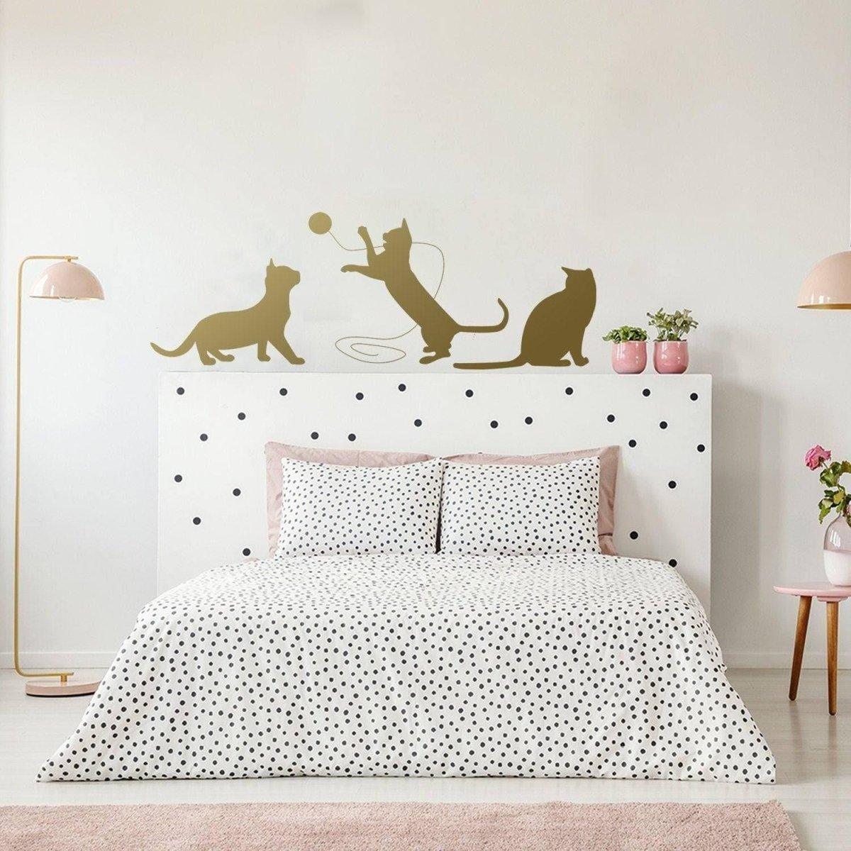Adorable cat silhouette decal above a bed.