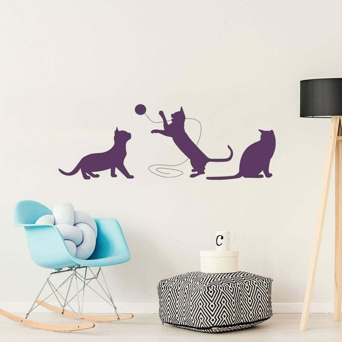 Adorable cat silhouette decal featuring three playful cats on a wall.