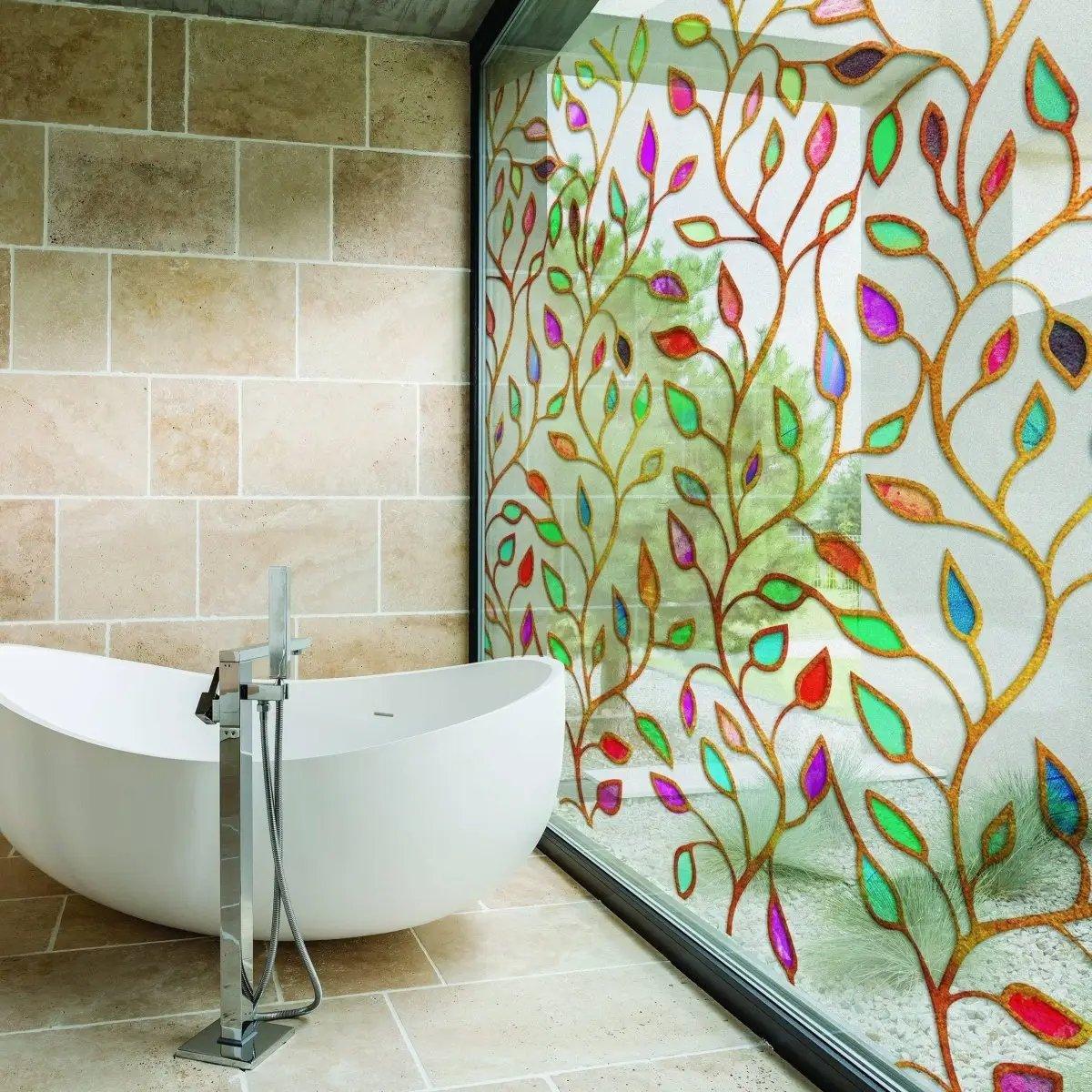 Elegant etched leaf design privacy glass window film in modern bathroom, allowing light while ensuring privacy.