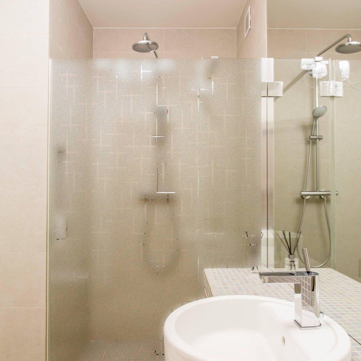 Modern bathroom featuring a frosted glass shower for privacy and natural light.