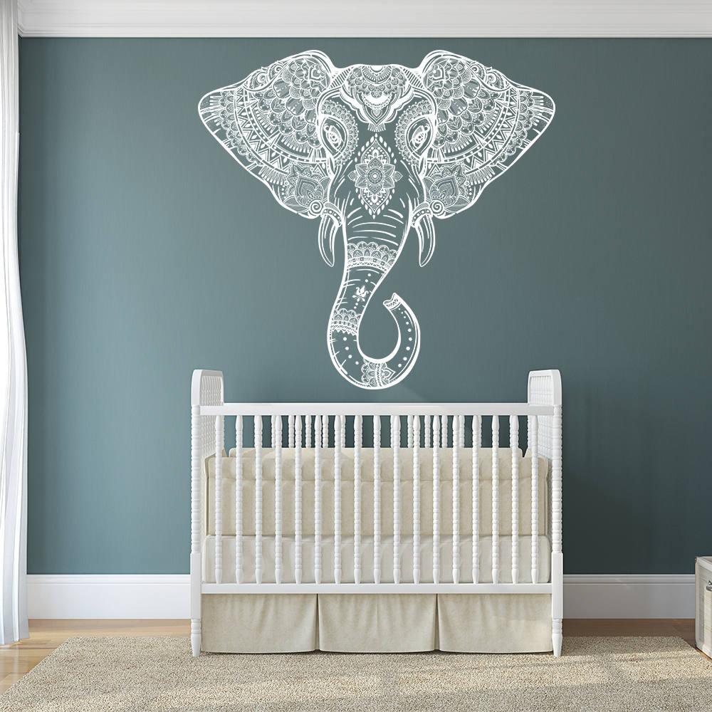 Elephant head wall vinyl sticker over a crib, showcasing Aztec geometric design in a nursery.