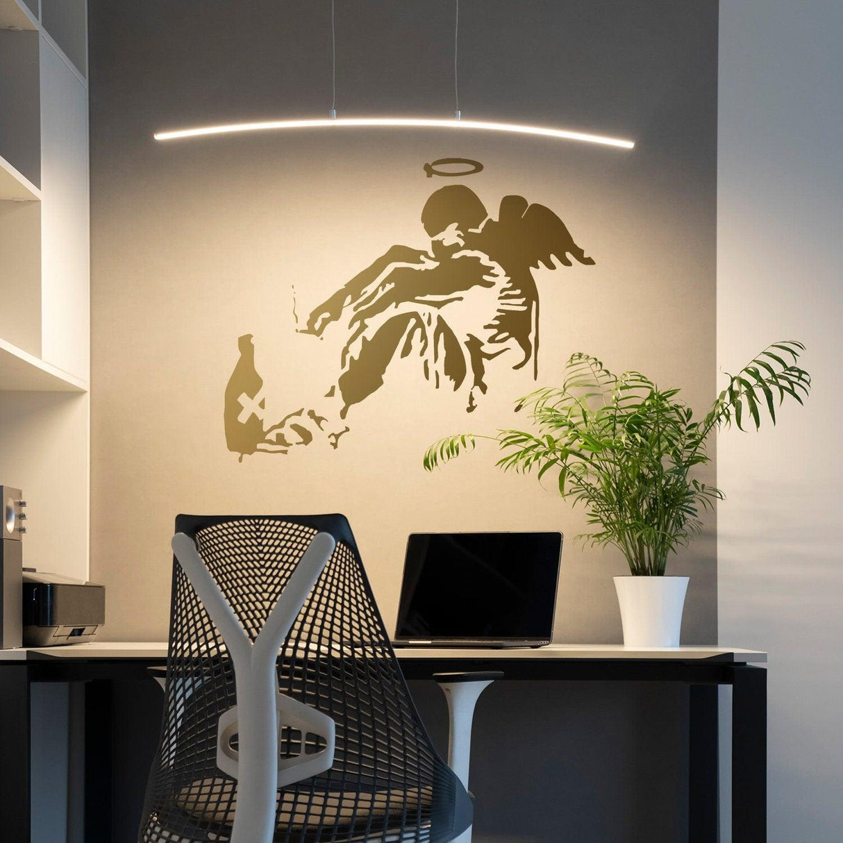 Fallen angel wall sticker in a modern office with a desk and plants.