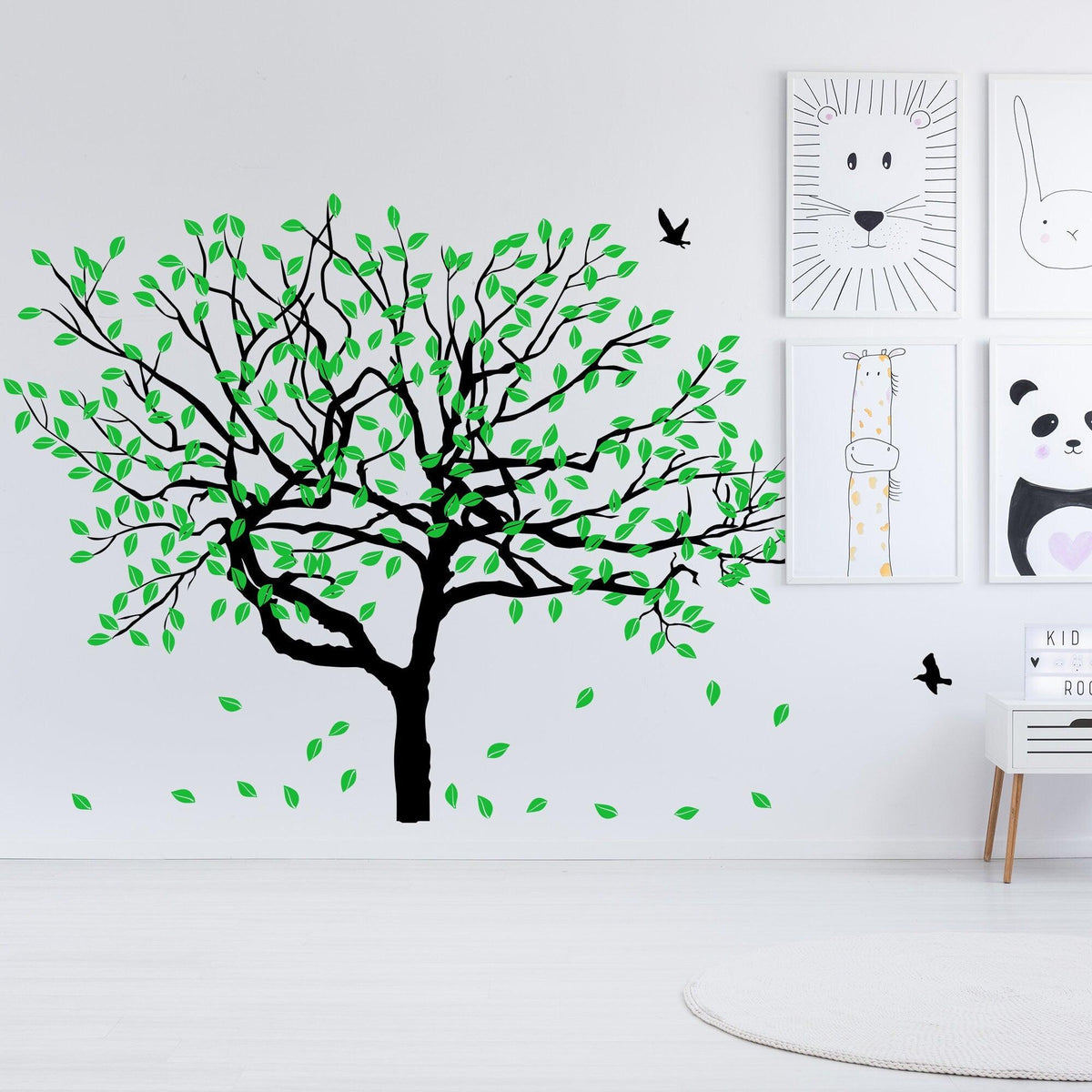 Stylish tree wall decal featuring green leaves and black trunk.