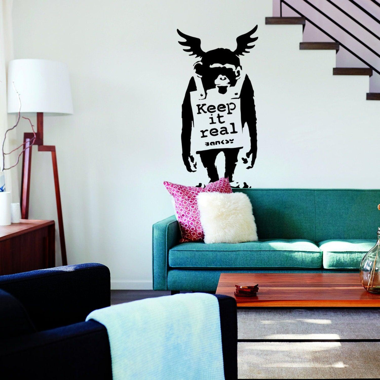 Monkey wall sticker with Keep It Real text in a modern living room.