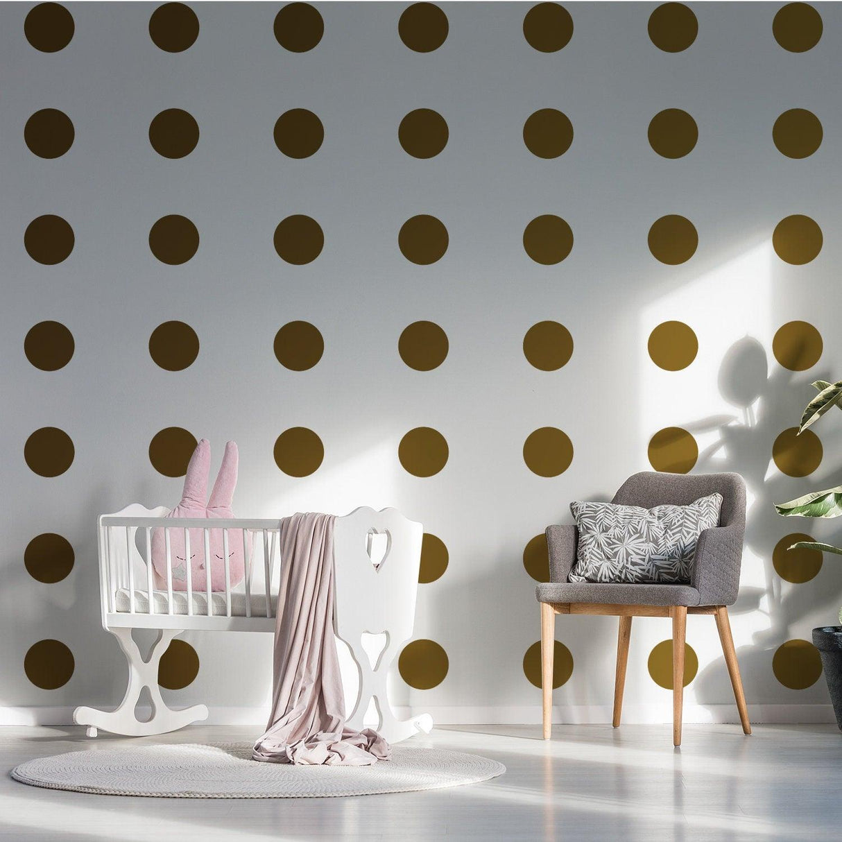 Elegant gold dot vinyl decals on nursery wall with crib and chair.