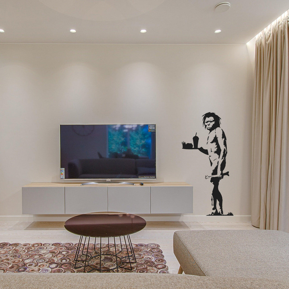 Caveman street art wall decal shown in an interior.