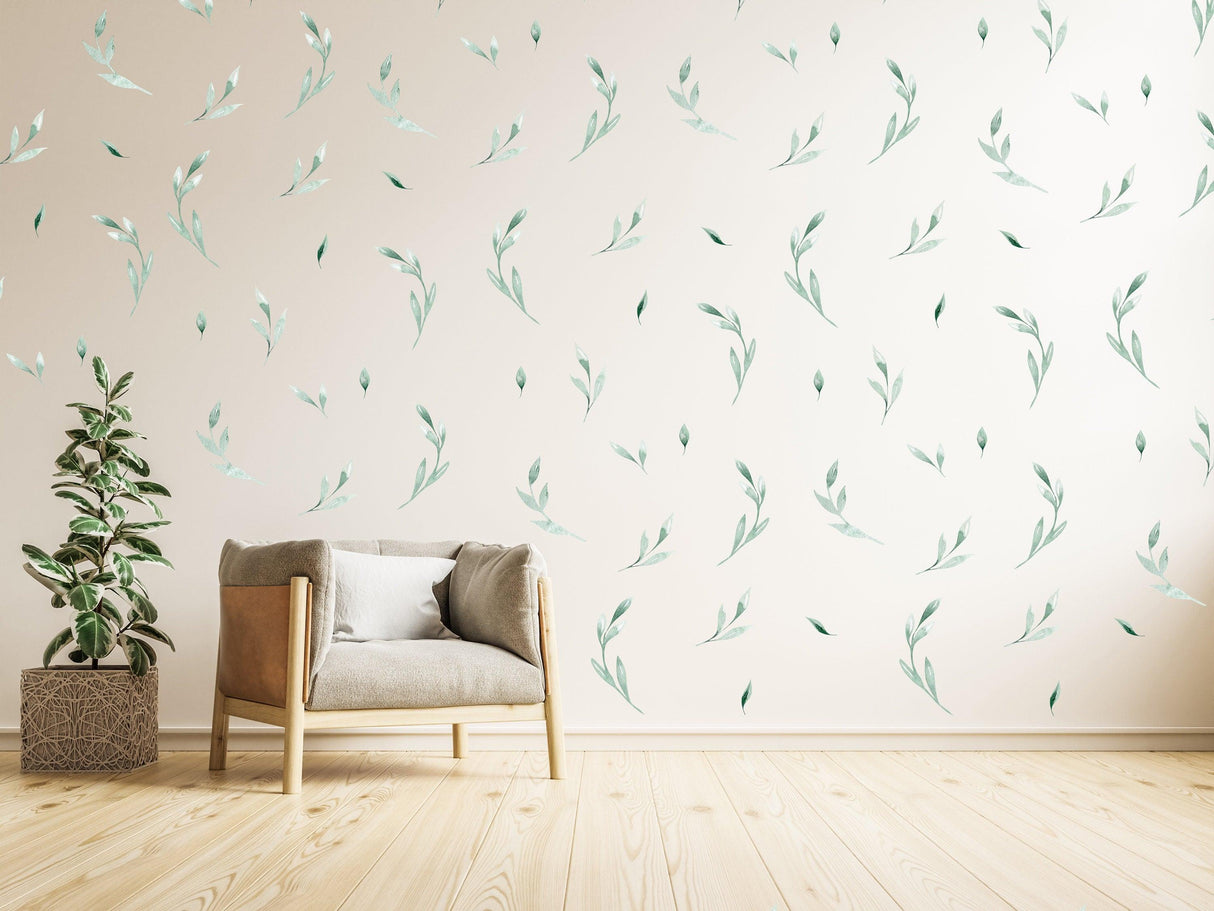 Stylish living room featuring olive leaves wall stickers, a cozy chair, and greenery for natural elegance.