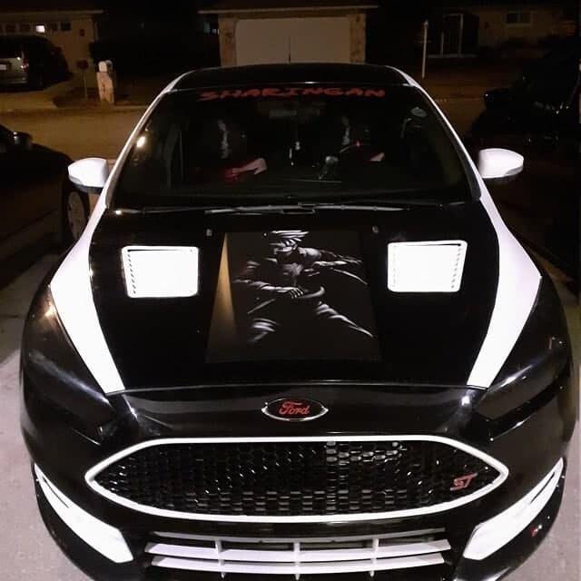 Custom decorated car with a black-and-white graphic applied to the hood.