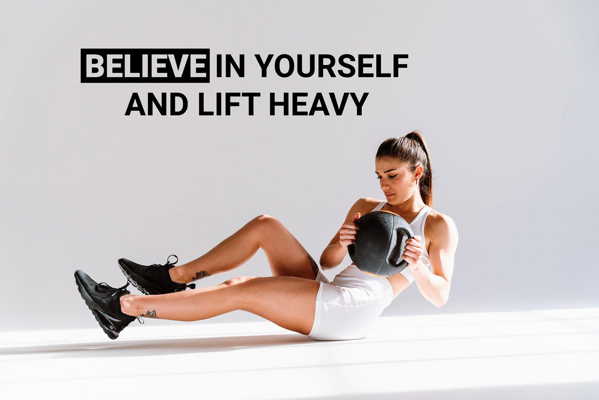 Motivational gym wall decal featuring the quote 'Believe in Yourself and Lift Heavy' with a woman exercising.