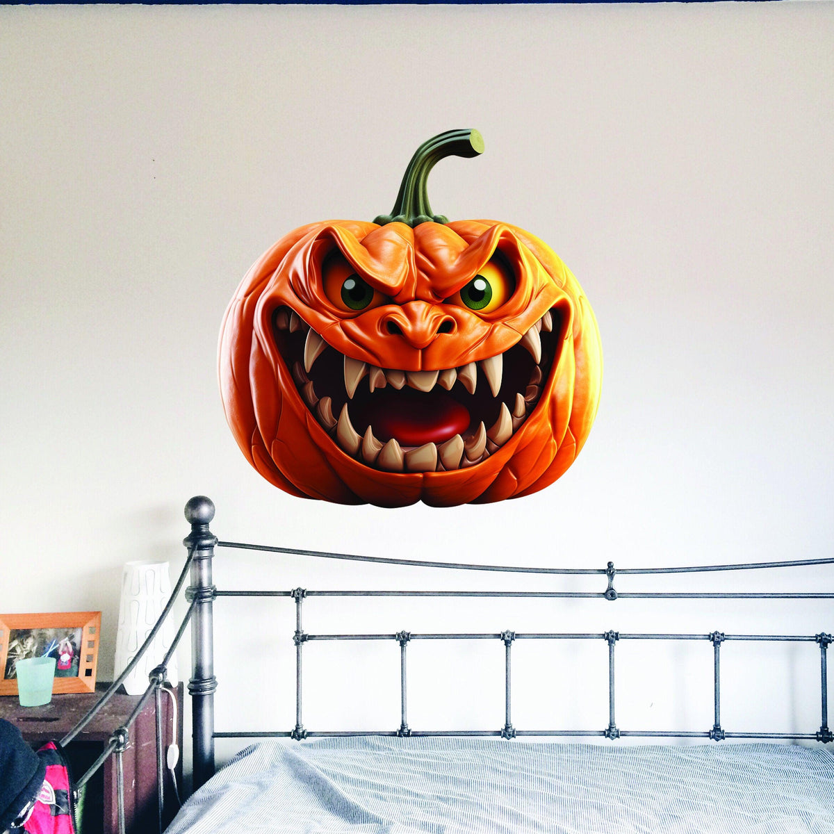 Large orange pumpkin-face vinyl wall decal with a printed broken-wall illusion.