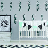 WhimsyArrows vinyl wall decals on nursery wall, crib with decorative bunting, and framed art.