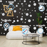 Cozy living room with white round dot stickers on black wall, showcasing creative decorating options.