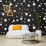 Cozy living space featuring white round dot stickers on a black wall, a comfortable chair, and modern decor.