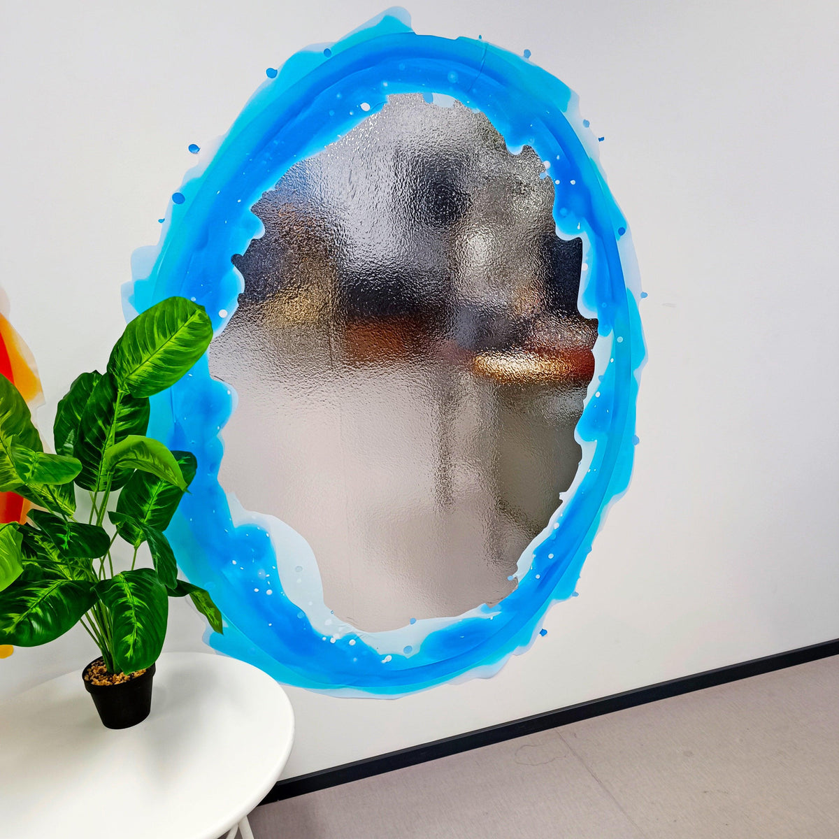 Blue portal aura wall sticker with vibrant colors, enhancing a modern space around a plant and furniture.