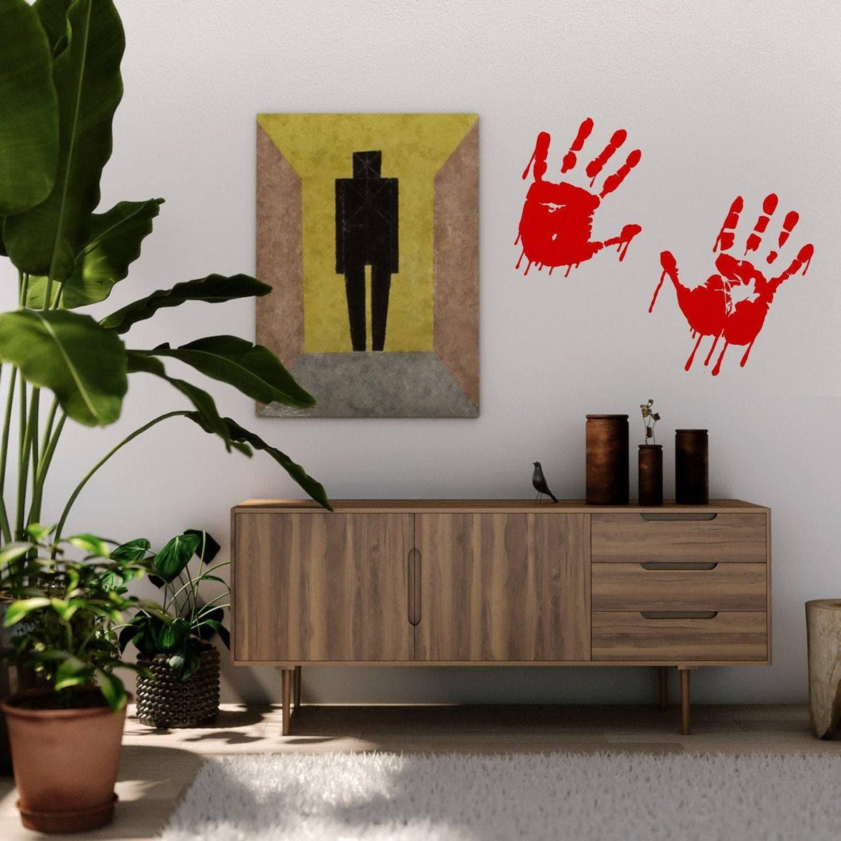 Spooky red handprint vinyl decals on wall near a modern wooden cabinet and potted plant.