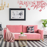 Whimsical butterfly wall art decal above a pink sofa in a stylish living room with modern decor.