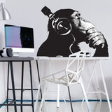 Vinyl wall art decal of a contemplative chimp wearing headphones.