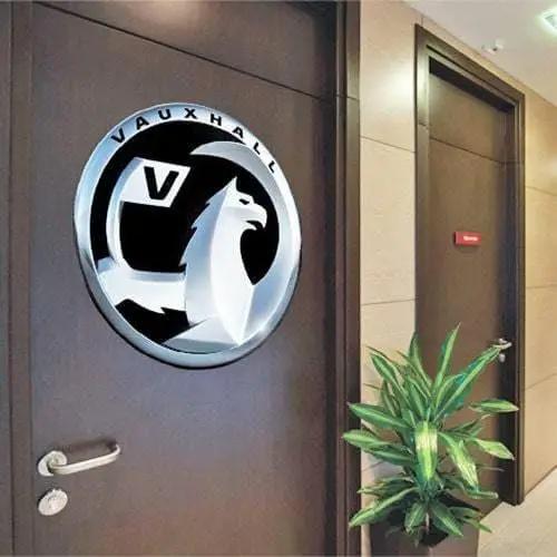 Personalized automotive emblem decal displayed on a wooden office door.