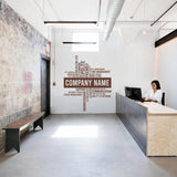 Modern office space featuring a personalized wall decal with 'Company Name' and motivational words.