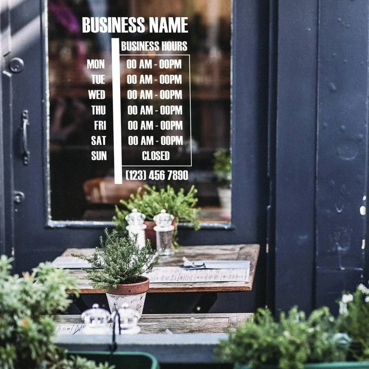 Personalized vinyl business hours decal displayed on a storefront window, detailing daily hours and contact information.