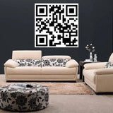 Custom QR code decal on wall above stylish white sofas in modern living room.