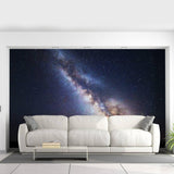 Stellar galaxy wall decal featuring a stunning night sky design behind a modern white couch.