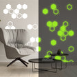50 glow-in-the-dark honeycomb wall decals with geometric hexagon shapes.