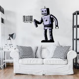 Wall decal of a retro robot spray painting a barcode on a white wall above a modern white couch.