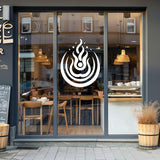Custom business logo vinyl decal on cafe window with modern decor and lighting.