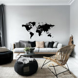 Minimalist black world map wall decal in modern living room decor with cozy seating and stylish accents.