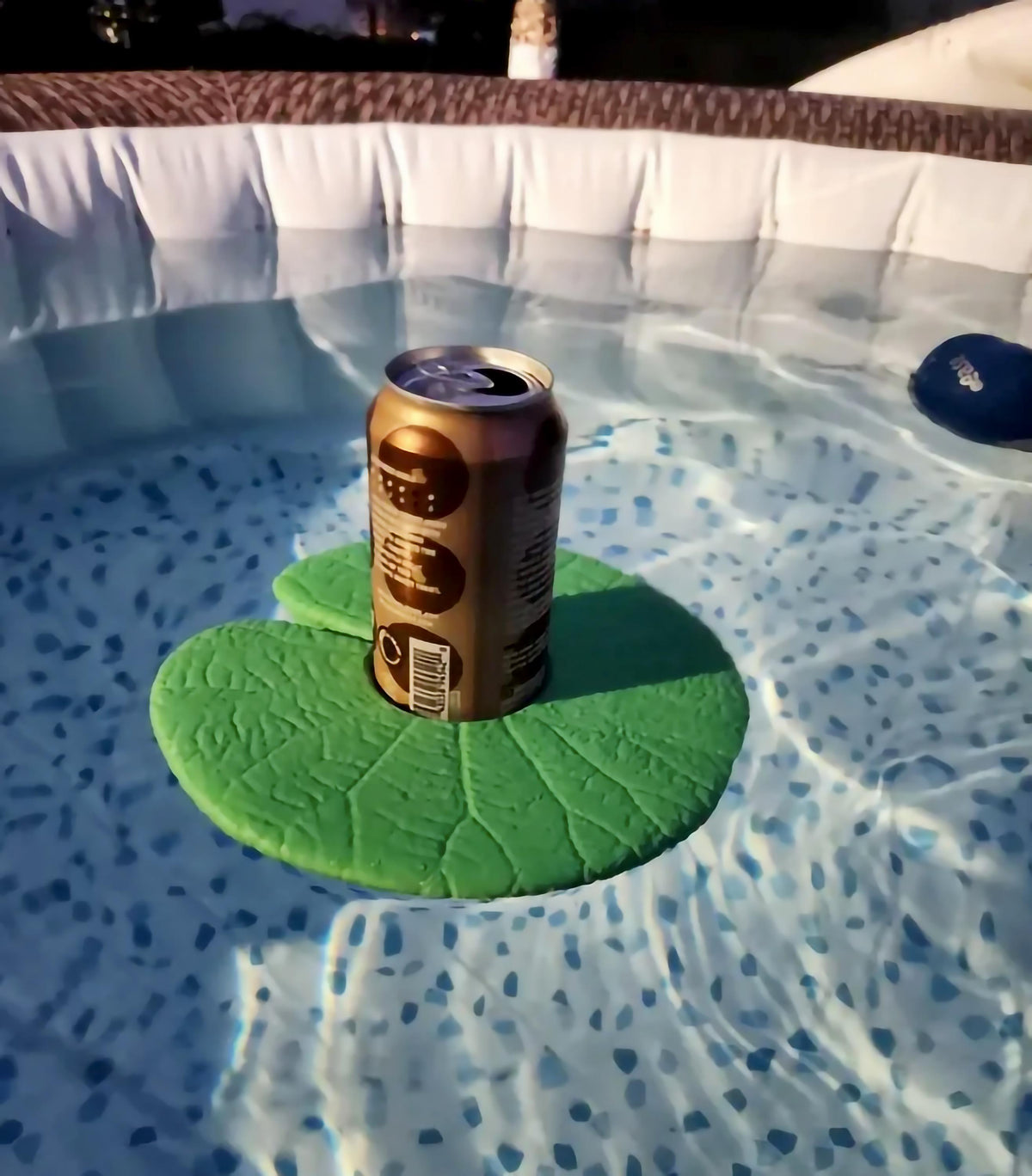 Lily Pad water cupholder floating in pool with a can.
