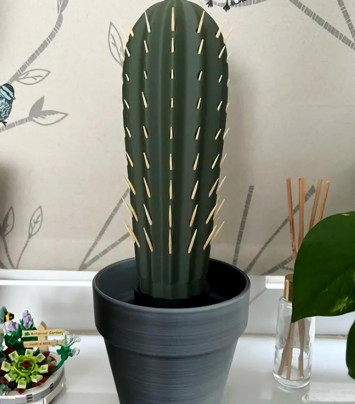 3D printed cactus toothpick holder in a pot with toothpicks resembling spines.